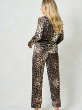 Load image into Gallery viewer, Hope & Ivy SINDY Leopard Pyjamas – women’s satin leopard print pyjama set with pink piping, button-up shirt and matching trousers. Perfect for lounging, gifting or travel.