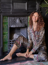 Load image into Gallery viewer, Hope & Ivy SINDY Leopard Pyjamas – women’s satin leopard print pyjama set with pink piping, button-up shirt and matching trousers. Perfect for lounging, gifting or travel.