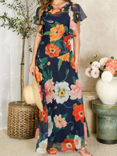 Load image into Gallery viewer, Hope & Ivy Jean Floral Dress – sustainable cowl-neck maxi dress with waterfall sleeves and hand-designed poppy print in red, pink, and orange. Made from 100% recycled materials. Perfect for weddings and summer occasions.