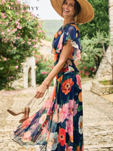 Load image into Gallery viewer, Hope & Ivy Jean Floral Dress – sustainable cowl-neck maxi dress with waterfall sleeves and hand-designed poppy print in red, pink, and orange. Made from 100% recycled materials. Perfect for weddings and summer occasions.