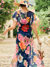 Load image into Gallery viewer, Hope & Ivy Jean Floral Dress – sustainable cowl-neck maxi dress with waterfall sleeves and hand-designed poppy print in red, pink, and orange. Made from 100% recycled materials. Perfect for weddings and summer occasions.