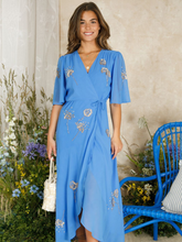 Load image into Gallery viewer, Hope & Ivy Mallory Blue Embellished Wrap Dress – elegant blue embellished maxi wrap dress with silver and gold detailing, flutter sleeves, and tie waist. Perfect for weddings and evening occasions.
