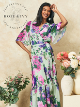 Load image into Gallery viewer, Hope & Ivy Priscilla Floral Dress – sustainable sage-green floral maxi wrap dress with flutter sleeves and tie waist. Made from 100% recycled materials. Perfect for weddings and summer occasions.