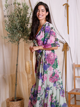 Load image into Gallery viewer, Hope & Ivy Priscilla Floral Dress – sustainable sage-green floral maxi wrap dress with flutter sleeves and tie waist. Made from 100% recycled materials. Perfect for weddings and summer occasions.
