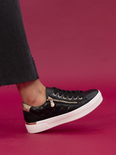 Load image into Gallery viewer, Black sneaker with gold zippers on a pink background