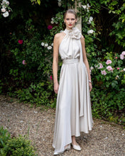 Load image into Gallery viewer, Maisonel ME3004 Oyster Dress – women’s halter neck satin occasion dress in elegant oyster tone with floral applique and asymmetric hem, perfect for weddings and formal events.