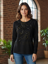 Load image into Gallery viewer, Malissa J WF2503 black sequin bow top—women’s embellished long-sleeve jersey top with statement bow detail.