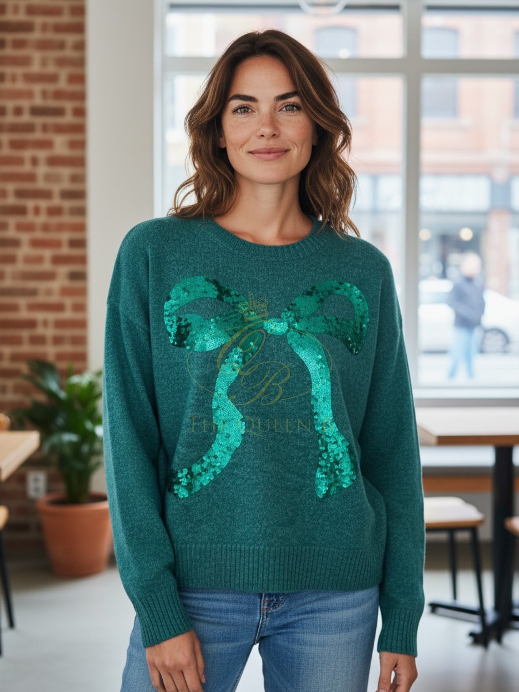 Green knit jumper with sequin bow detail, crew neckline, and ribbed hem from Paramour.