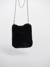 Load image into Gallery viewer, Women’s black faux fur crossbody bag with slim chain strap – soft plush evening bag perfect for winter outfits and chic day-to-night styling.