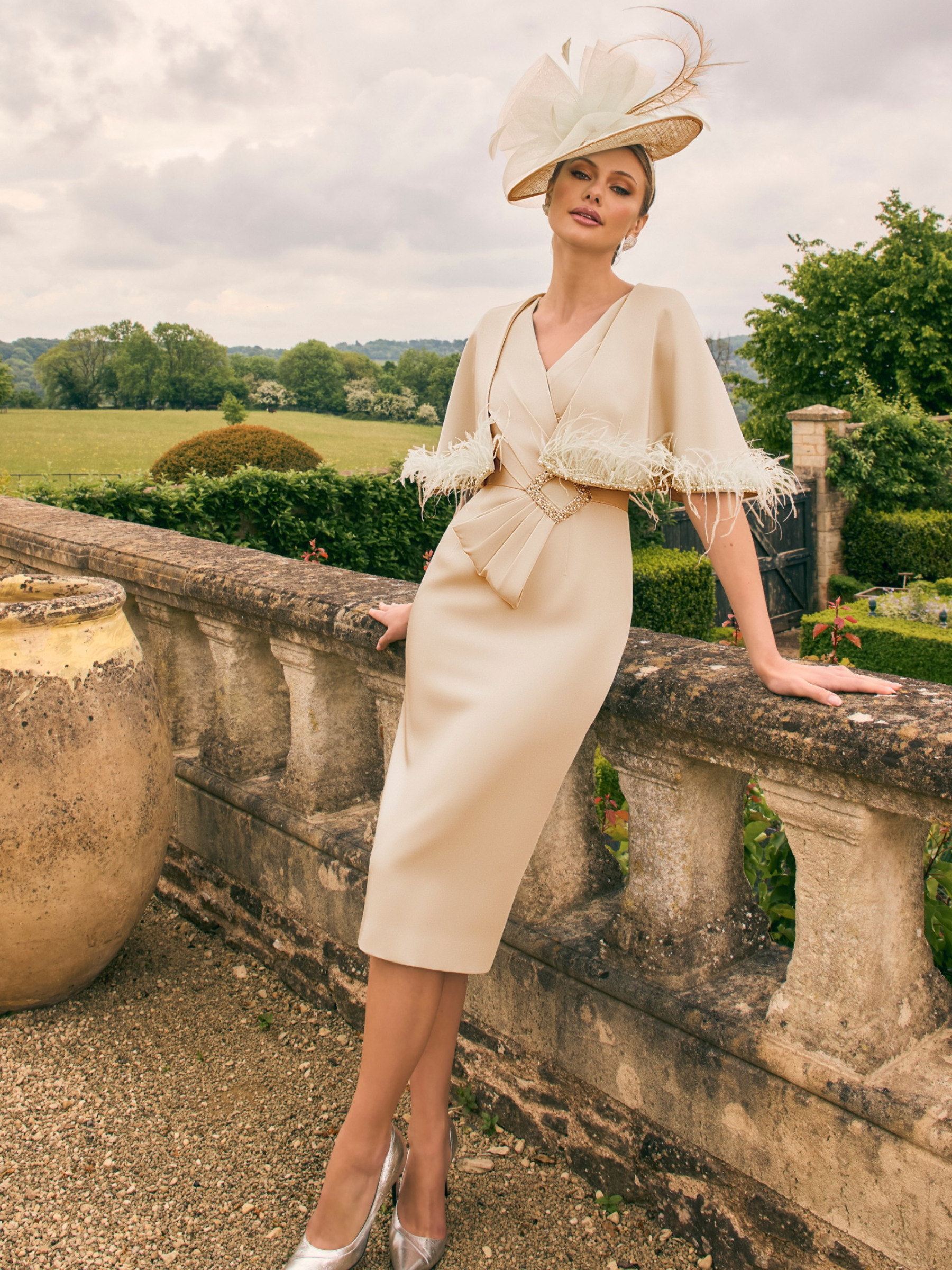Veni Infantino 992754 Creme dress with matching cape, featuring crepe fabric, beaded trim and feather detailing. Elegant Mother of the Bride/Groom outfit for weddings and special occasions.