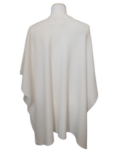 Load image into Gallery viewer, Cape by Alice Collins featuring button detailing on the shoulder, patch pockets, and a high neckline – soft lightweight knit ideal for layering and casual everyday wear.
