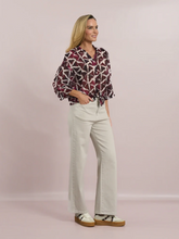 Load image into Gallery viewer, Deck by Decollage abstract print button-front blouse in berry and neutral tones, featuring a tie hem, wide sleeves, and a lightweight viscose fabric-ideal for effortless, everyday elegance.
