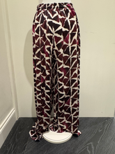 Load image into Gallery viewer, Deck by Decollage wide-leg trousers with an abstract berry and ivory print, featuring an elasticated waistband and fluid silhouette-designed for bold, stylish comfort.
