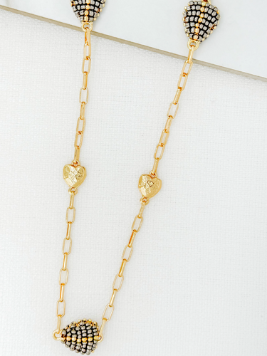 ENVY 4515 Necklace featuring a gold-effect longline chain with alternating textured gold-effect hearts and black-and-gold beaded heart pendants, a women’s statement heart necklace perfect for versatile styling.
