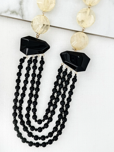 ENVY 4614 Necklace with layered black-effect beaded strands, faceted black-effect stones, and round neutral-effect beads, designed as a bold statement necklace for day-to-night styling.