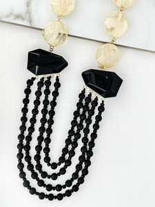ENVY 4614 Necklace with layered black-effect beaded strands, faceted black-effect stones, and round neutral-effect beads, designed as a bold statement necklace for day-to-night styling.