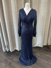 Load image into Gallery viewer, Frank Lyman 239808U Navy Sequin Dress – full-length evening gown with V-neckline, long sleeves, and flattering wrap-style fit. Elegant navy blue sequin occasion dress perfect for black-tie events and special occasions.
