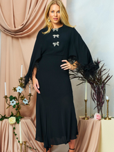 Load image into Gallery viewer, Hope &amp; Ivy HELENA black midi occasion dress with feather-trimmed sleeves and embellished bows, perfect for Christmas parties, winter weddings and evening events.
