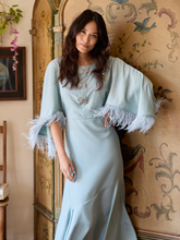 Load image into Gallery viewer, Hope &amp; Ivy LUCIA blue midi occasion dress with feather-trimmed sleeves and embellished bows, perfect for Christmas parties, winter weddings and evening events.
