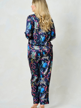 Load image into Gallery viewer, Hope &amp; Ivy SUZANNE Zebra Pyjamas – women’s satin pyjama set featuring hand-painted zebra and floral print, blue piping, button-up shirt and matching trousers. Ideal for lounging, gifting or travel.
