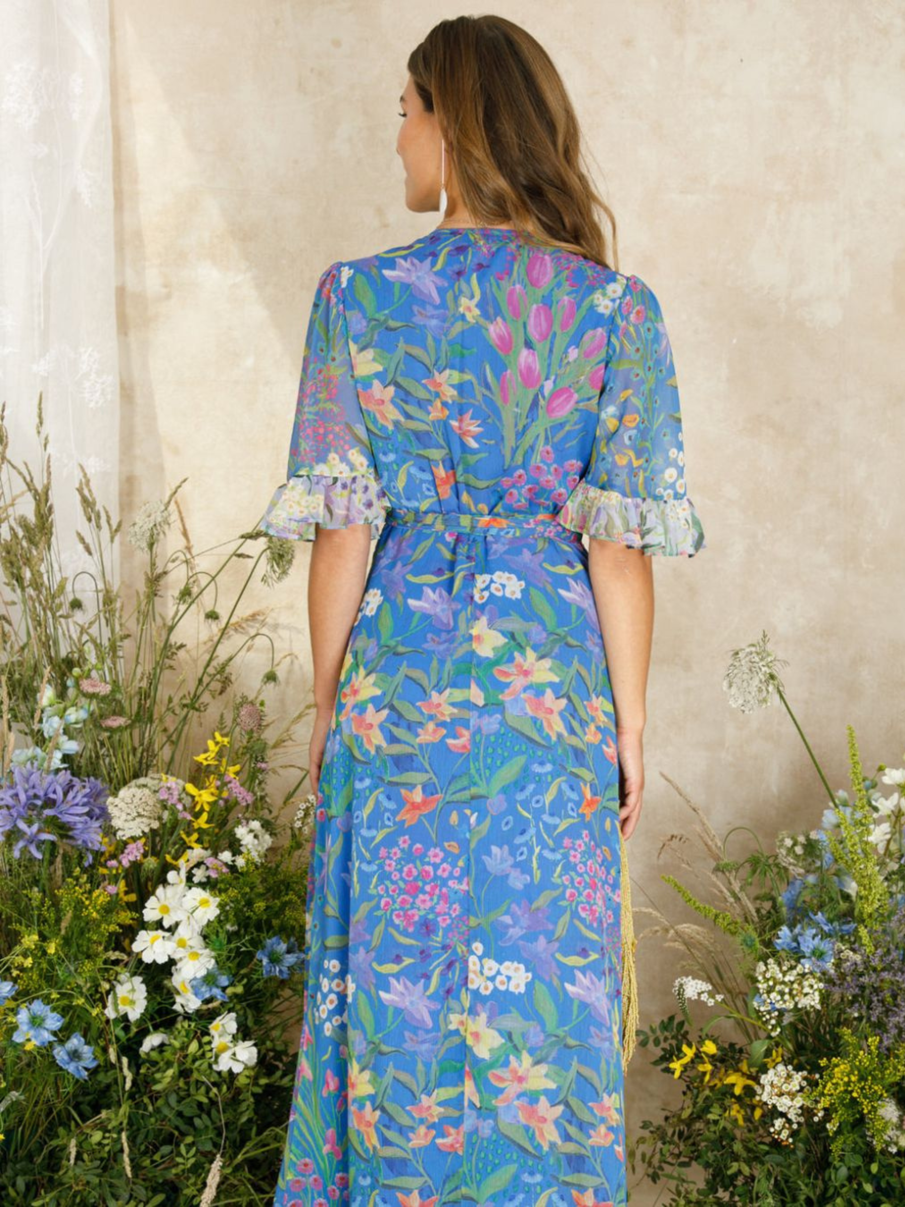 Hope & Ivy Avaline Floral Frill Trim Maxi Wrap Dress – women’s blue floral wrap dress with frilled hem and flutter sleeves. Hand-designed print with tie waist. Perfect for weddings, garden parties, and special occasions.