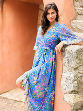 Load image into Gallery viewer, Hope &amp; Ivy Avaline Floral Frill Trim Maxi Wrap Dress – women’s blue floral wrap dress with frilled hem and flutter sleeves. Hand-designed print with tie waist. Perfect for weddings, garden parties, and special occasions.
