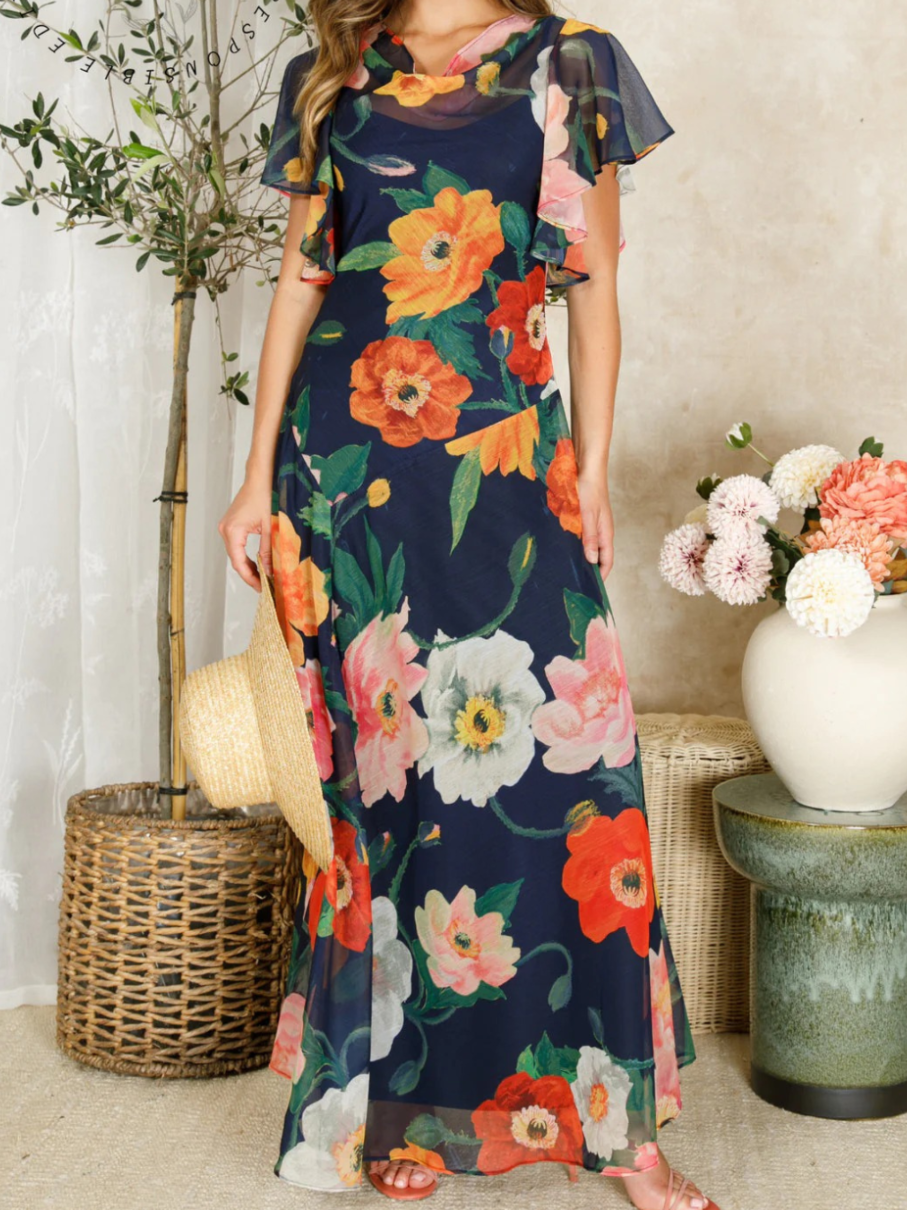 Hope & Ivy Jean Floral Dress – sustainable cowl-neck maxi dress with waterfall sleeves and hand-designed poppy print in red, pink, and orange. Made from 100% recycled materials. Perfect for weddings and summer occasions.