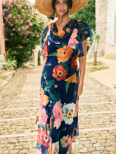 Hope & Ivy Jean Floral Dress – sustainable cowl-neck maxi dress with waterfall sleeves and hand-designed poppy print in red, pink, and orange. Made from 100% recycled materials. Perfect for weddings and summer occasions.