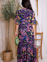 Load image into Gallery viewer, Hope &amp; Ivy Nesta Floral Wrap Dress – sustainable navy floral chiffon wrap dress with flutter sleeves and tie waist. Made from 100% recycled materials. Perfect for weddings, garden parties, and summer occasions.

