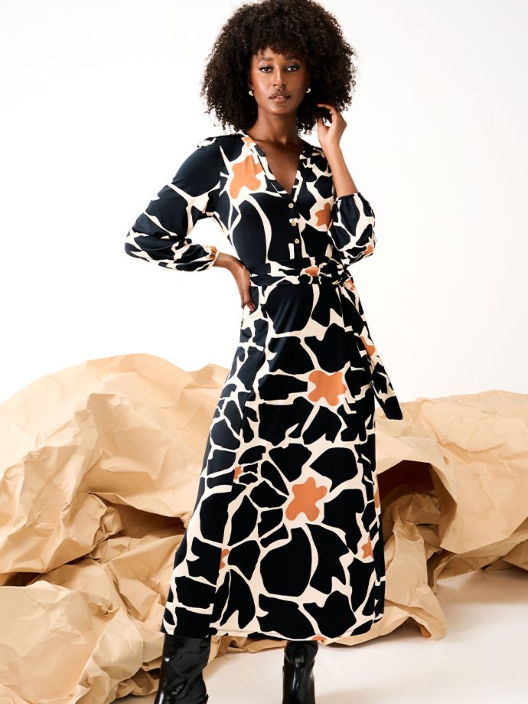 Women’s belted midi dress in burgundy and white abstract floral print with wrap waist, V-neckline and long sleeves for elegant autumn styling.