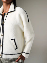 Load image into Gallery viewer, K Design B846 women’s black and white cardigan with contrast trim, gold-tone buttons, and front pockets - timeless knitwear for layering in autumn-winter.
