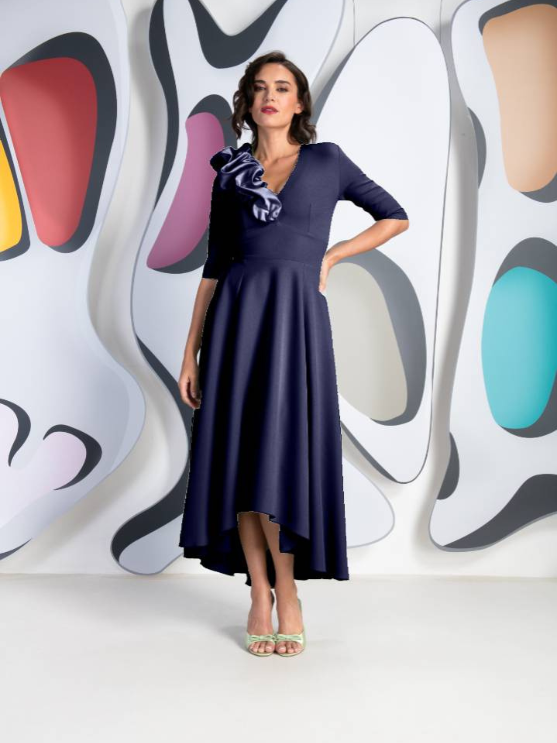 Kevan Jon Betty B Navy Satin Scrunchie Dress – elegant navy satin dress with sculptural shoulder detail, V-neckline and asymmetric hemline. Perfect for weddings, formal events and evening occasions.
