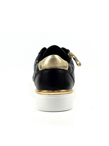 Black sneaker with gold accents on a white background