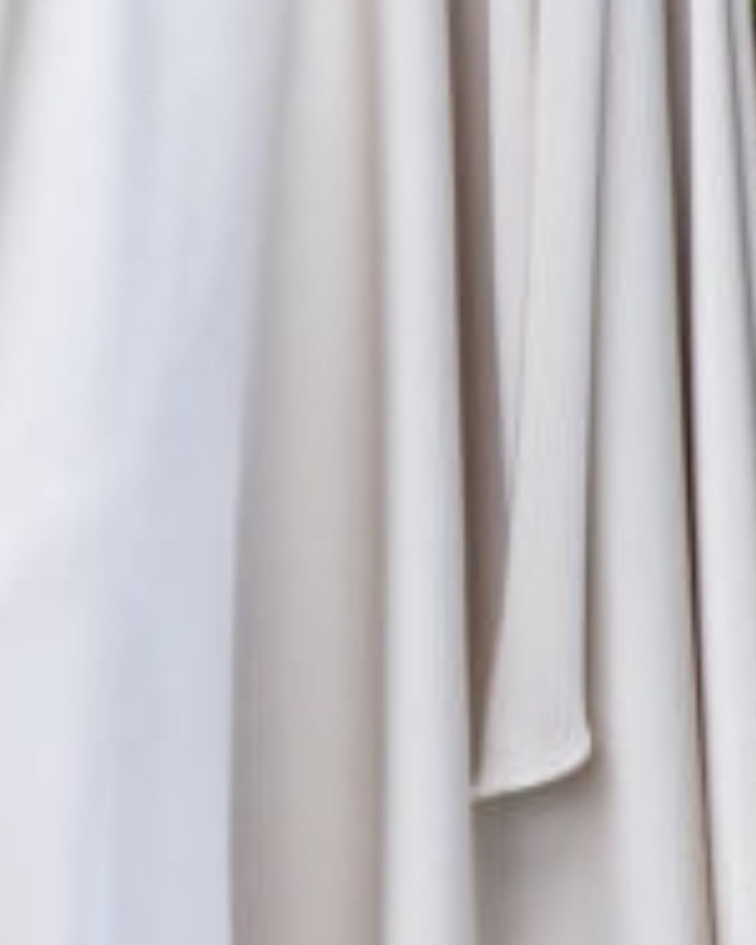 Maisonel ME3003 Oyster Dress – women’s satin occasion dress with flutter sleeves, gathered waist detail, and asymmetric hemline in elegant oyster tone. Perfect for weddings and formal events.