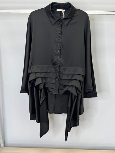 Black layered shirt on a hanger against a white background