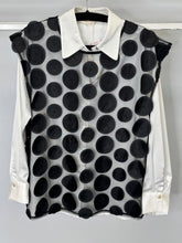 Load image into Gallery viewer, Black polka dot vest over a white shirt on a hanger against a gray background
