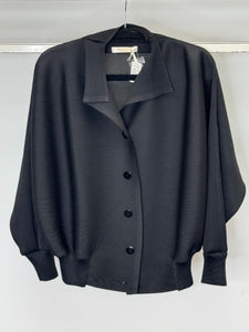 Black button-up shirt on a hanger against a white background