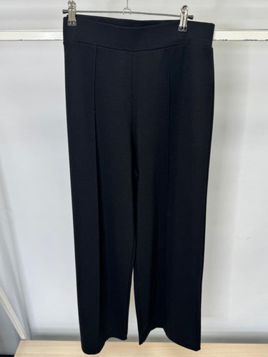 Black pants on a hanger against a white background