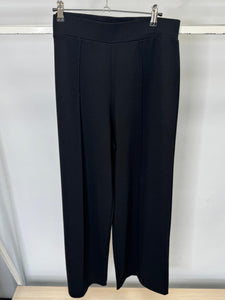 Black pants on a hanger against a white background