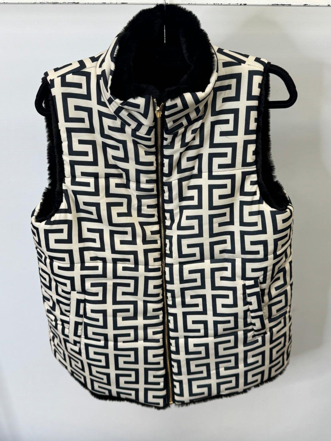 Black and white patterned vest with fur trim on a white background