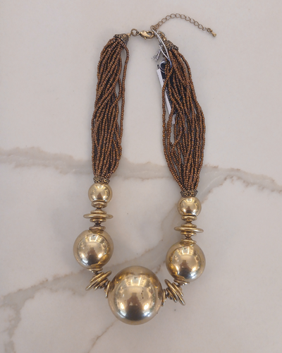 Necklace with gold beads and brown tassels 