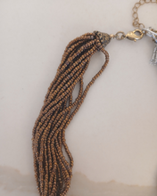 Load image into Gallery viewer, Necklace with gold beads and brown tassels 
