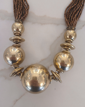 Load image into Gallery viewer, Necklace with gold beads and brown tassels 
