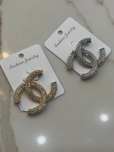 Load image into Gallery viewer, Nouvelle CC Brooch Silver – luxury women’s crystal brooch with double C design, silver-tone finish and sparkling rhinestones. Perfect statement accessory for blazers, scarves and evening wear.
