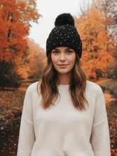 Load image into Gallery viewer, PCHA SD117 Black Sequin Pompom Hat – black knit hat with sequins and faux fur pompom, also available in red and cream. Perfect for chic winter styling.
