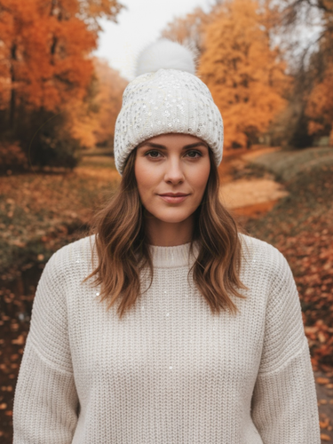 PCHA SD117 Cream Sequin Pompom Hat – cream knit hat with sequins and faux fur pompom, also available in black and red. Ideal for chic winter styling.