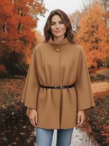 The QBAW25 RR Camel Carrie Cape features a structured silhouette with wide sleeves, a high neckline and elegant gold button detailing. Finished with a detachable belt for a flattering fit, this chic cape blends timeless tailoring with modern sophistication - perfect for layering over seasonal outfits.