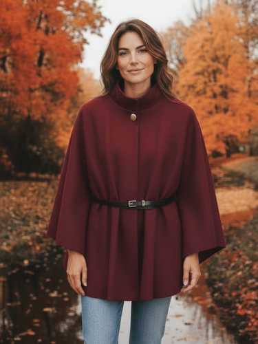 The QBAW25 RR Wine Carrie Cape features a structured silhouette with wide sleeves, a high neckline and elegant gold button detailing. Finished with a detachable belt for a flattering fit, this chic cape blends timeless tailoring with modern sophistication - perfect for layering over seasonal outfits.