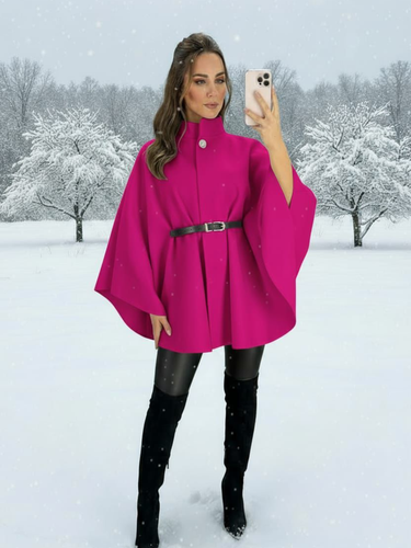 The QBAW25 RR Fuchsia Carrie Cape features a structured silhouette with wide sleeves, a high neckline and elegant gold button detailing. Finished with a detachable belt for a flattering fit, this chic cape blends timeless tailoring with modern sophistication - perfect for layering over seasonal outfits.